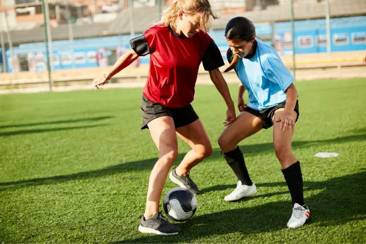 Soccer players participate in a 1v1 drill at soccer practice