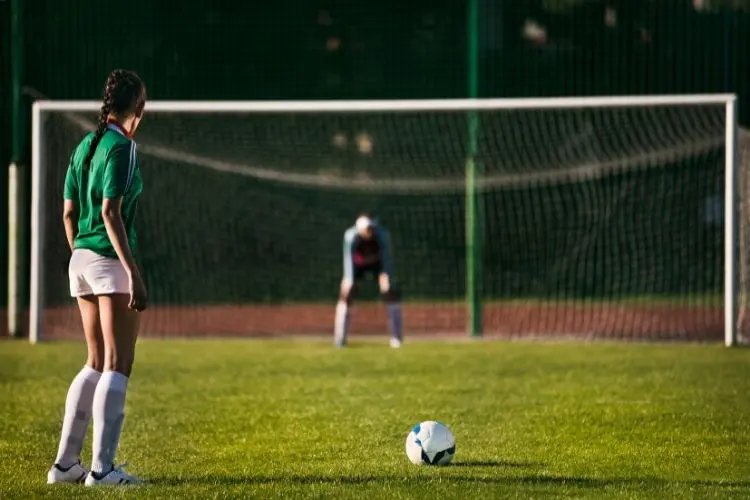 Soccer player prepares to take a penalty kick during a soccer game